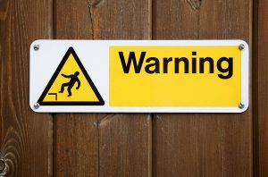 Warning sign with man falling